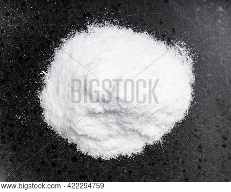 Top View Of Pile Of Dextrose Sugar Close Up On Black Ceramic Plate