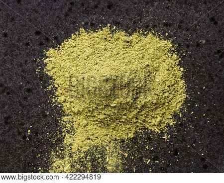 Top View Of Pile Of Milled Stevia Rebaudiana Herb (natural Sugar Substitute) Close Up On Black Ceram