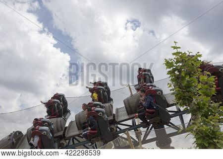 Salou, Spain, May 1, 2020 - Furious Baco Riders Over Port Aventura Amusement Park Against Cloudy Sky