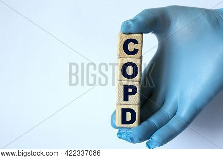 Copd (chronic Obstructive Pulmonary Disease) Is An Acronym On Cubes Held By A Hand In A Blue Glove. 