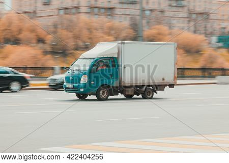Blue Cargo Van Kia Bongo 3 In The City Street. Kia Jumbo In Fast Motion With Blurred Background. Mos