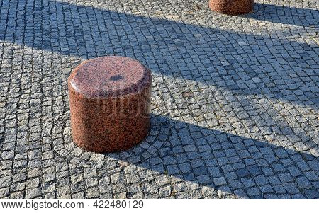 Circular Fountain Of Polished Granite Brown To Red Granite. Square With Stone Benches And Stone Cobb