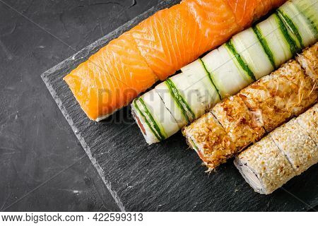 Appetizing Set Of Sushi Roll On A Black Stone Plate