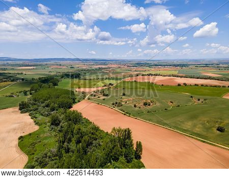 Aerial View Of Fields Of Castile With Agricultural Plots And Blue Sky With Clouds. Castilla.