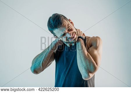 Exhausted Young Sportsman Feel Neckache In Studio