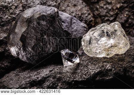Rough Diamond Next To A Cut Diamond, In A Coal Mine, Concept Of Mining And Mineral Extraction