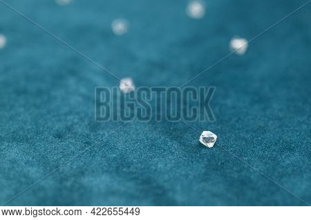 Several Large Faceted Diamonds Lie On The Blue Velvet. Close-up Photo.
