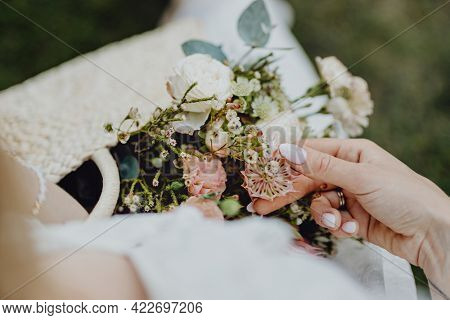Woman with a woven bag full of flowers