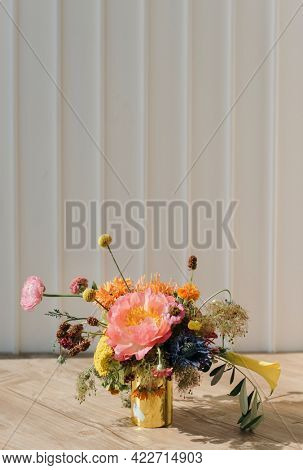 Gold vase with fresh flowers