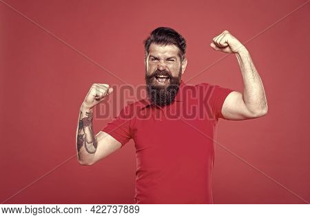 Strength And Drive. Bearded Man Show Strength. Strong Hipster Flex Arms Red Background. Strength And