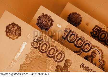 Russian Banknotes 5000, 1000 And 500 Rubles Close Up. Brown Tinted Wallpaper, Background Or Backdrop