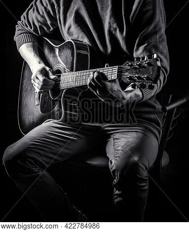 Male Musician Playing Guitar, Music Instrument. Mans Hands Playing Acoustic Guitar, Close Up. Acoust