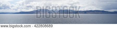 Arran Viewed From Rothesay In Isle Of Bute Under Dark Clouds
