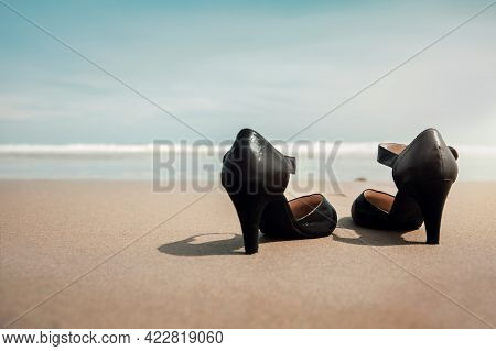 Work Life Balance Concept. Business Woman Take Off Working Shoes And Leave It On The Sand Beach For 