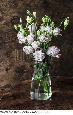 Home Still Life Interior. Eustom Bouquet In A Glass Vase On A Wooden Background