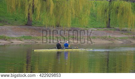 Kyiv Ukraine, The Dnieper River - May 02 2021: Two Unknown Young Athletes Are Sailing In A Two-seate