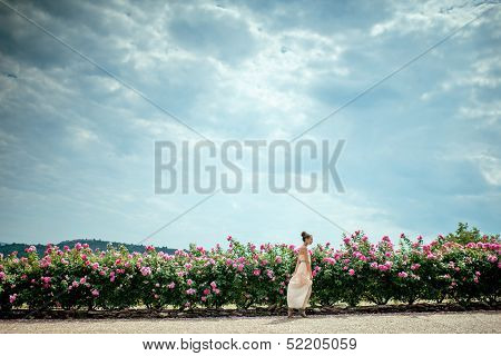 Running Lady In The Garden Of Roses