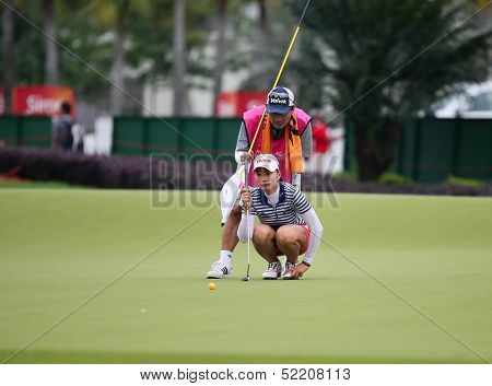 KUALA LUMPUR - OCTOBER 12: Chella Choi of South Korea lines up for her putt on the 2nd hole green of the KLGCC course on Day 3 of the Sime Darby LPGA on October 12, 2013 in Kuala Lumpur, Malaysia.