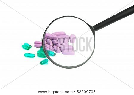 Green And Purple Pills Through Magnifier