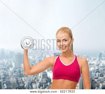 fintess, healthcare and dieting concept - young sporty woman with heavy steel dumbbell