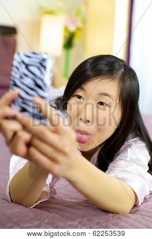 Asian Girl Having Fun Making Funny Faces For Selfie
