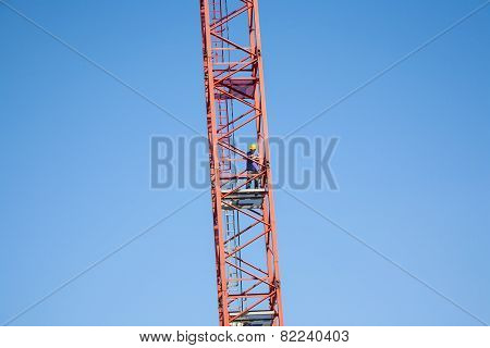 Worker Climbs A Tall Crane