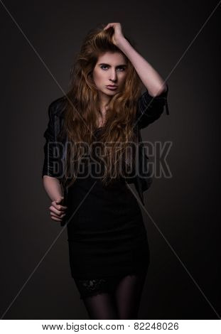 Attractive Woman In Black Dress And Leather Jacket