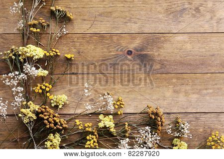 Dried flowers on rustic wooden planks background