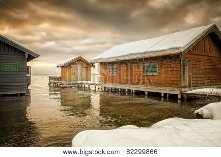 An image of the lake huts in Tutzing Bavaria Germany at winter sunrise