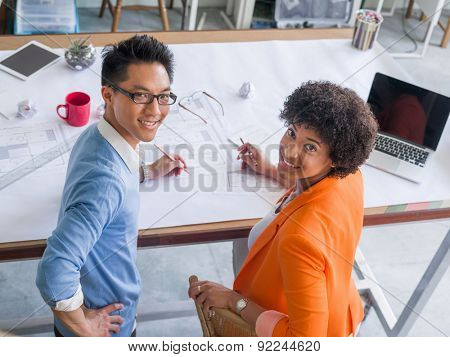 Two desingers working on a project together in office