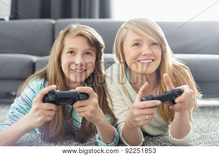 Sisters playing video games in living room