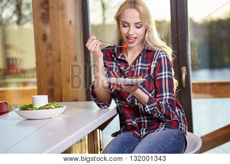 Woman in home eating breakfast