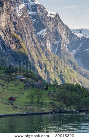 Traditional Norwegian houses on the banks of the Geirangerfjord