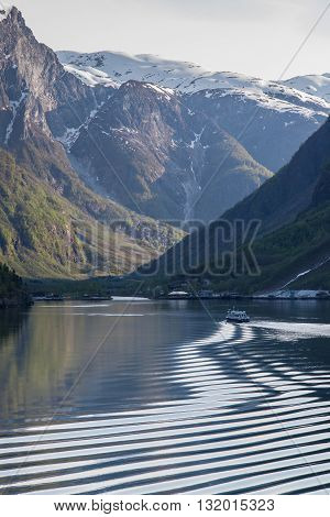 Ship on the Geirangerfjord travels into the distance