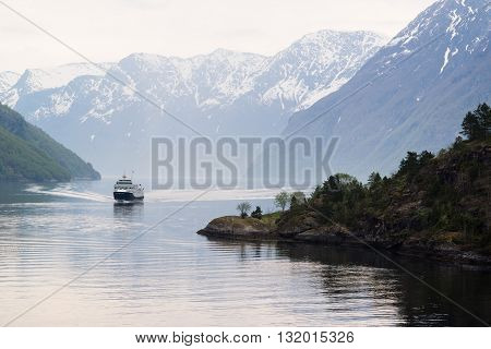 Ship approaching Geiranger on the Geirangerfjord in the early morning.