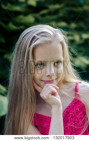 Portrait of a beautiful blonde little girl with long hair