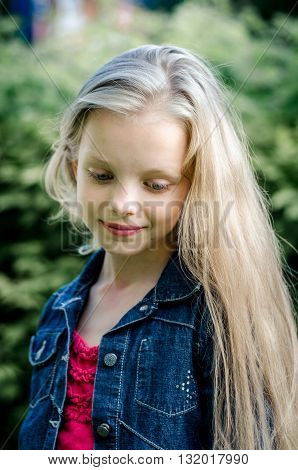 Portrait of a beautiful blonde little girl with long hair