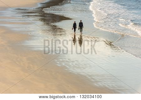 Happy Romantic Couple Walking On The Atlantic Beach