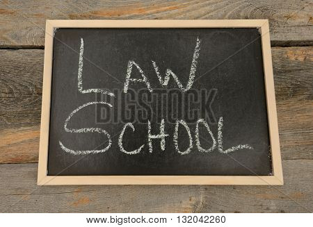 Law School written in chalk on a chalkboard on a rustic background
