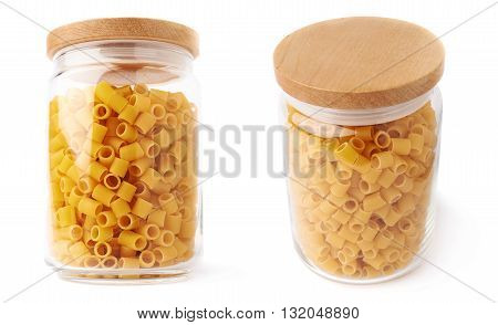 Set of glass jar filled with dry ditalini yellow pasta over isolated white background, different foreshortenings