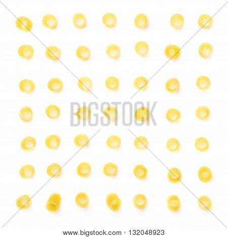Single pieces of dry ditalini yellow pasta over isolated white background