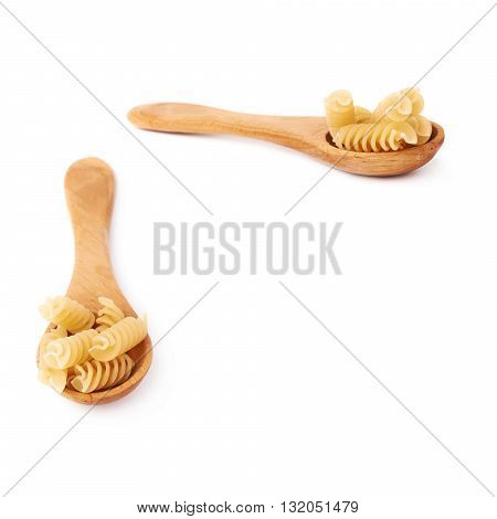 Set of wooden spoon filled with dry rotini yellow pasta over isolated white background, different foreshortenings