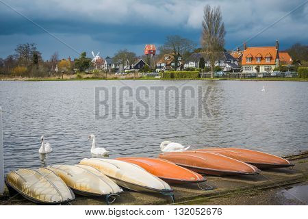 Swans and boats at Thorpeness Boating Lake and the House in the Sky