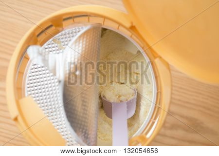 can of powdered milk for children on wooden table close up