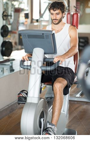 Man working out on a stationary bike in a gym