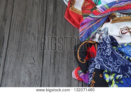 Pile of colorful scarves on a table.