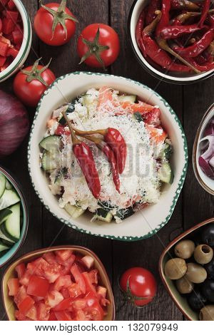 Shopska salad with cheese, tomato, cucumber, onion and chili peppers