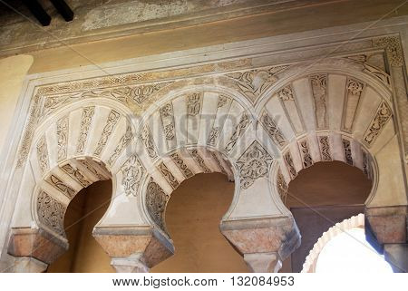 MALAGA, SPAIN - JULY 11, 2008 - Ornate arches within the Nasrid Palace Malaga Castle (Alcazaba de Malaga) Malaga Malaga Province Andalucia Spain Western Europe, July 11, 2008.