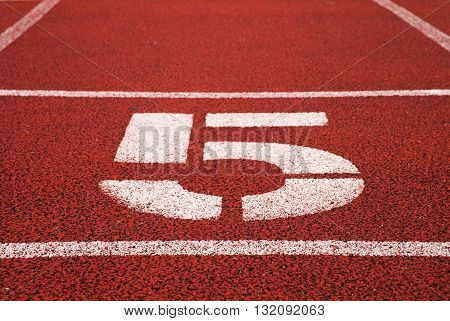 Number Five. Big White Track Number On Red Rubber Racetrack. Gentle Textured Running Racetracks In S