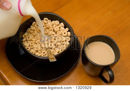 Colazione composta da cereali con latte e caffè con panna